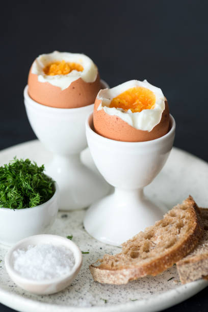 istock Boiled eggs with sea salt and toasted bread for breakfast 938718684