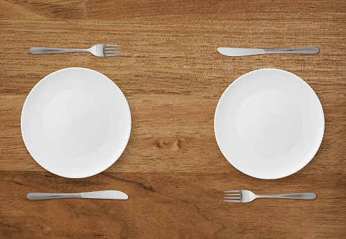 Table setting for two on wood background