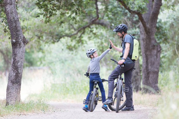 istock family biking in the park 938729370