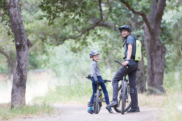 istock family biking in the park 938731812