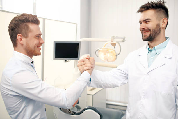 istock The handshake of two young male dentists 938732330