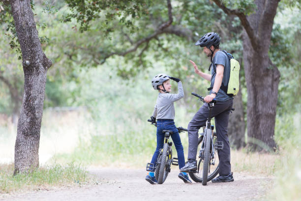 family biking in the park stock photo