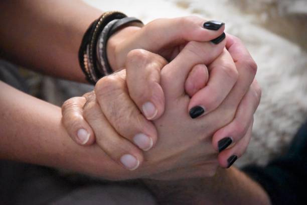 istock Close-Up Of Couple Holding Hands 938738214
