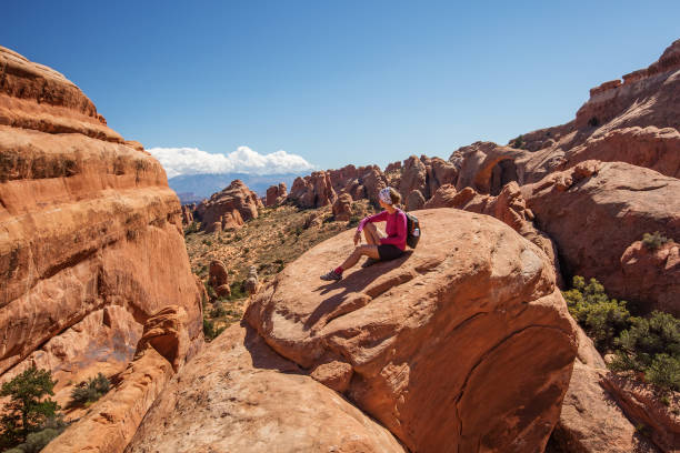 istock Hiker rests in Arches National park in Utah, USA 938743380