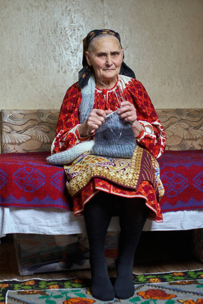 istock Old woman knitting 938747674