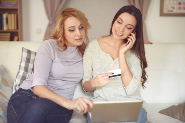 istock Mom and daughter using laptop 938748004