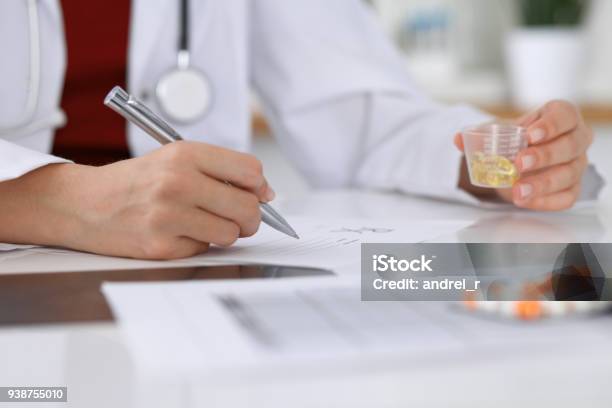 Female Medicine Doctor Fills Up Prescription Form To Patient Closeup Panacea And Life Save Prescribe Treatment Legal Drug Store Contraception Concep Stock Photo - Download Image Now