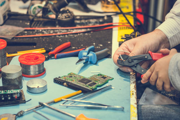 istock Close up of cutting wire with pliers in engineering laboratory. 938764242