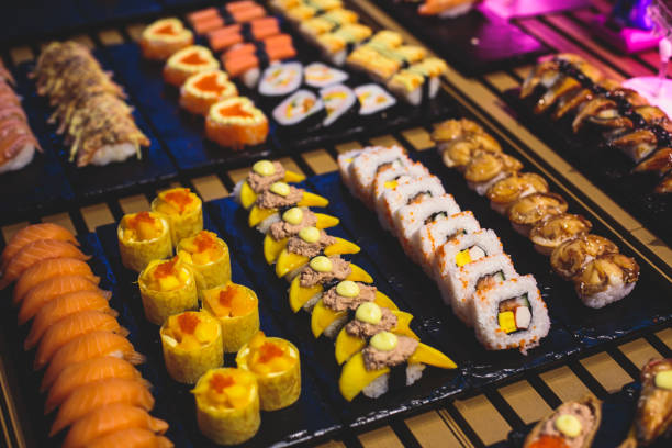 istock Decorated catering banquet table with different sushi rolls and nigiri sushi plate assortment on a party 938766010