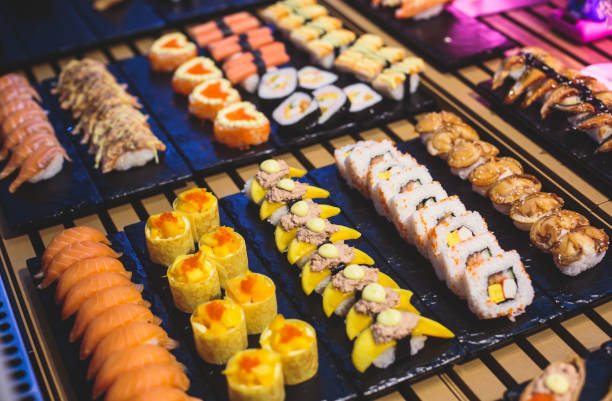 istock Decorated catering banquet table with different sushi rolls and nigiri sushi plate assortment on a party 938766022