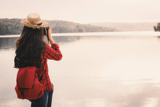 istock Young Woman Standing By Lake Against Clear Sky 938767178