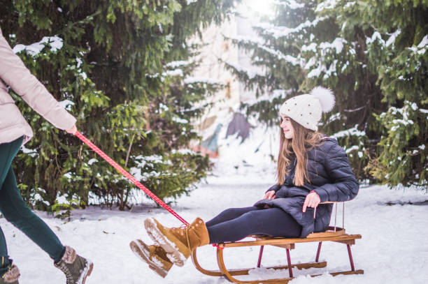 istock Sister twins having fun on snow 938769940