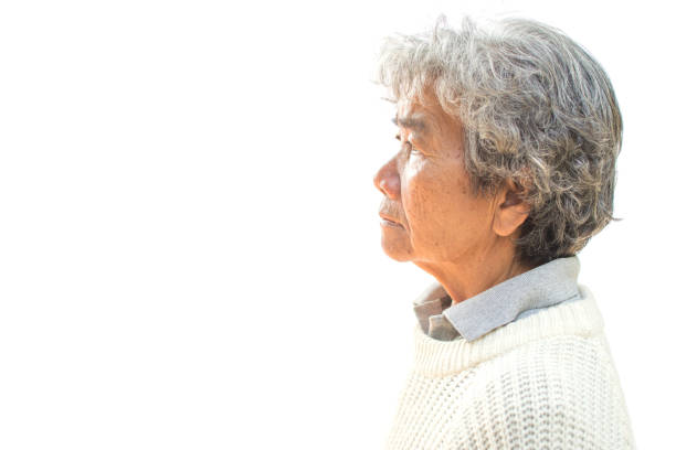 istock Thoughtful Senior Woman Standing Against White Background 938771540