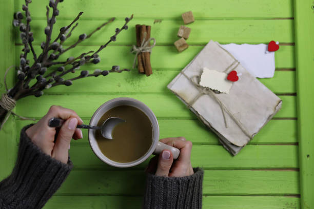 istock Girl drinking hot coffee and looks presented valentines 938778392