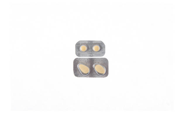 istock two plates of yellow tablets on white isolated background 938778886