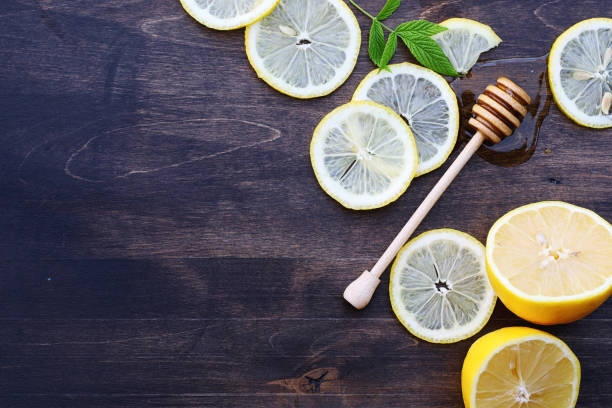 istock On a wooden texture background a lemon and honey 938787452
