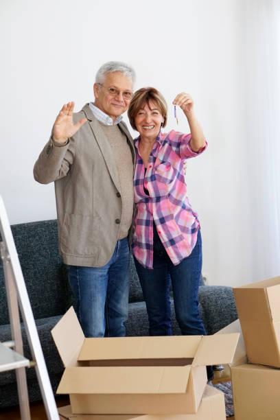 istock Senior couple moving into a new apartment 938788744