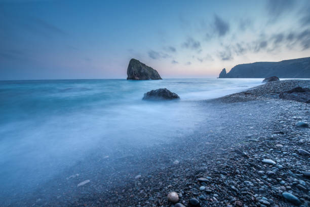 istock Scenic sunset on a rocky seashore on long exposure 938791792