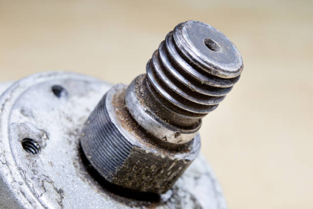 istock Old worn out gears in an angular gear. Mechanical accessories designed for regeneration in a repair shop. Black background. 938793008