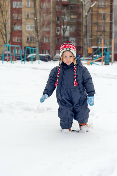 istock the boy is walking in the snow 938796178
