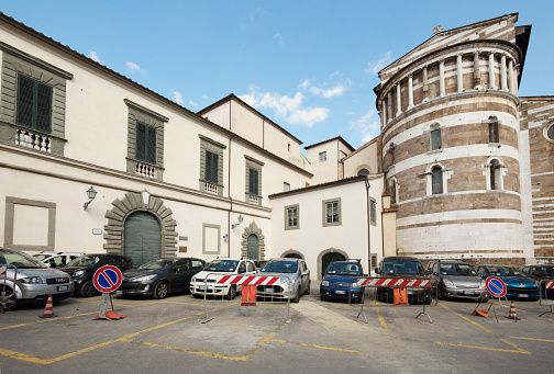Car park and historical landmarks in Lucca, Tuscany. Lucca is a historic town. Although basically everything inside its ancient walls are art, landmarks and monuments, no special permit is required to enter the town, on the contrary, vehicles and public transport can enter the town through its several entry points (\