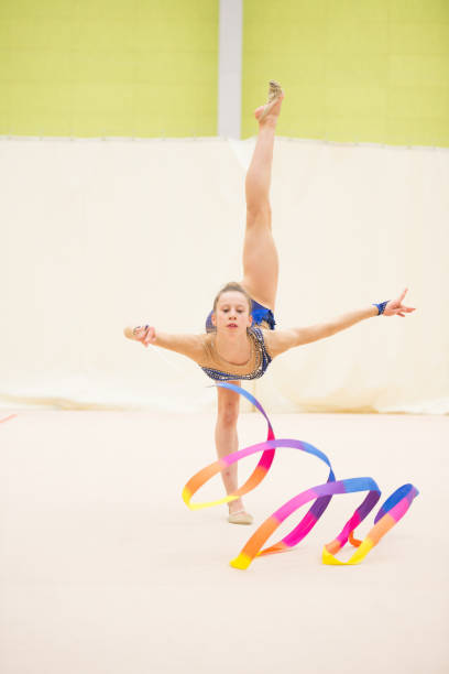 istock Young Rhythmic Gymnastics Athlete Dancing with Ribbon on one Leg 938819166