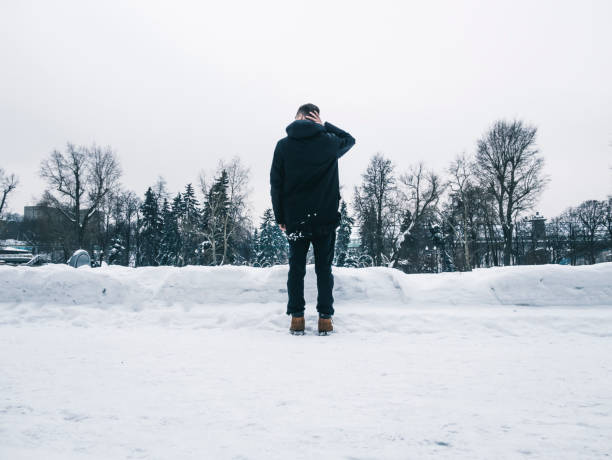 istock young man walking outside on a winter day, freezing cold weather 938819548
