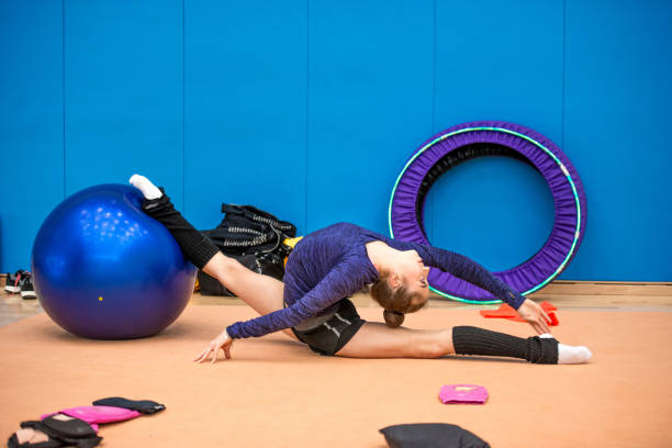 istock Young Rhythmic Gymnastics Athlete Stretching 938819668