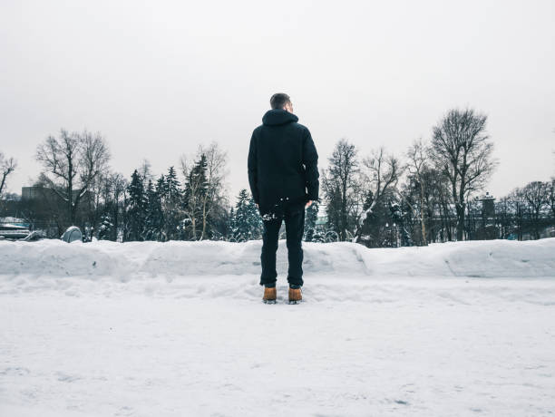 istock young man walking outside on a winter day, freezing cold weather 938819676