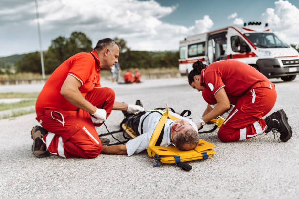 istock man on the ground after a car crash with the paramedic 938820064