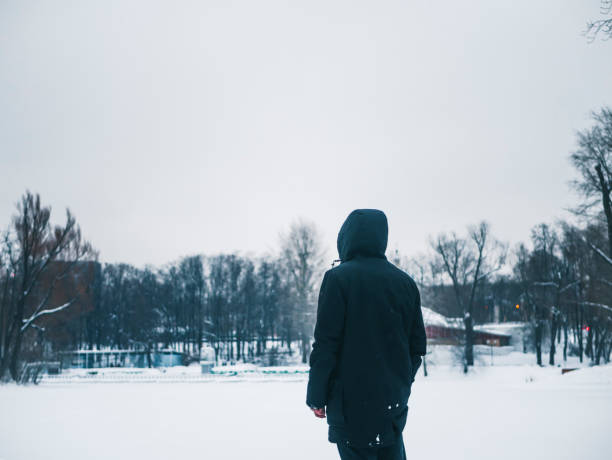 istock young man walking outside on a winter day, freezing cold weather 938820506