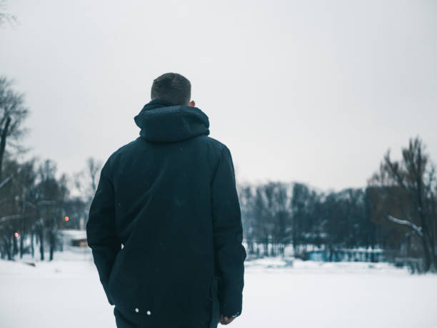 istock young man walking outside on a winter day, freezing cold weather 938820508