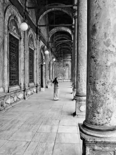 Woman at The Great Mosque of Muhammad Ali Pasha in Cairo, Egypt Woman among the architecture at The Great Mosque of Muhammad Ali Pasha in Cairo, Egypt. ept stock pictures, royalty-free photos & images