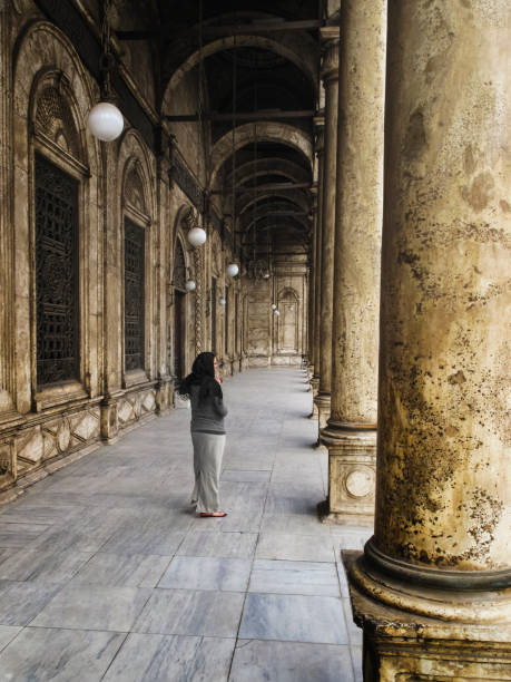 Woman at The Great Mosque of Muhammad Ali Pasha in Cairo, Egypt Woman among the architecture at The Great Mosque of Muhammad Ali Pasha in Cairo, Egypt. ept stock pictures, royalty-free photos & images