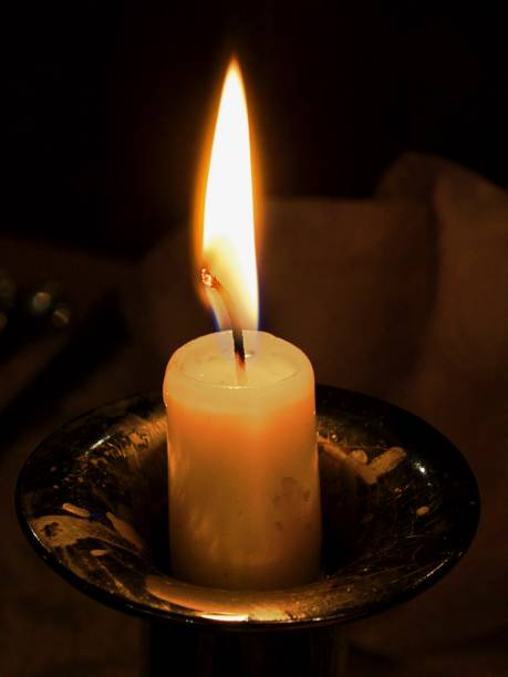istock Close-Up Of Illuminated Candle 938824724