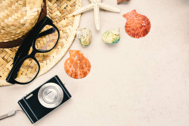 istock Close-Up Of Camera With Seashells And Hat On Table 938827762