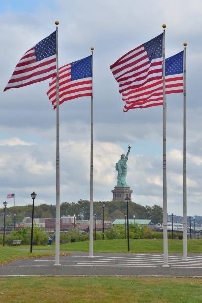 istock American Flag Against Statue Of Liberty 938828058