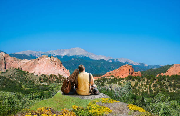 istock Happy couple resting and enjoying beautiful mountain view. 938832044
