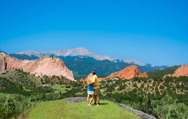 istock Happy couple resting and enjoying beautiful mountain view. 938838964
