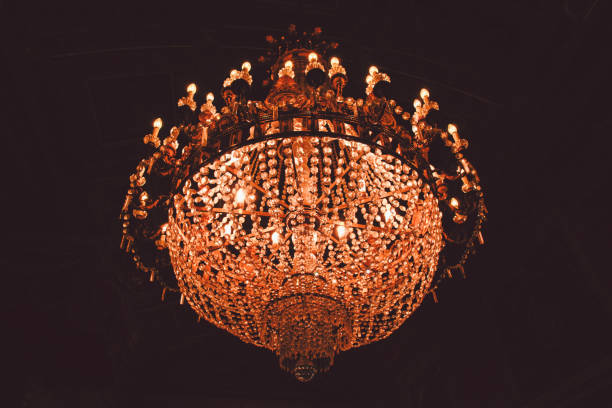 istock Low Angle View Of Illuminated Chandelier Hanging From Ceiling At Night 938839610