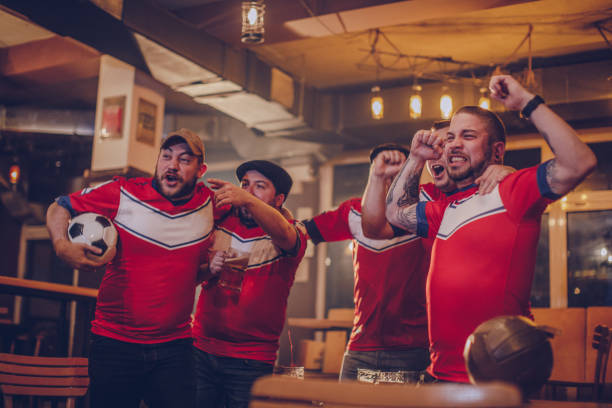 istock Men watching game at sports bar 938843410
