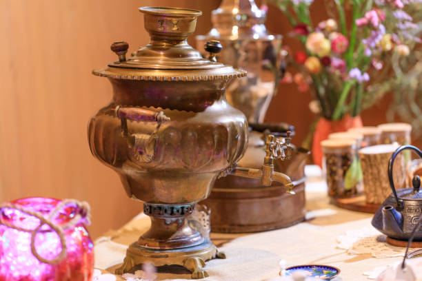istock Samovar in a worn but functional condition: Russian traditional tea-drinking. Old vintage samovar on a restaurant table: kind of traditional teapot boiler. 938862632