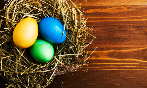istock Easter eggs on a wooden background .Easter eggs of different colors .Easter eggs top view 938862924