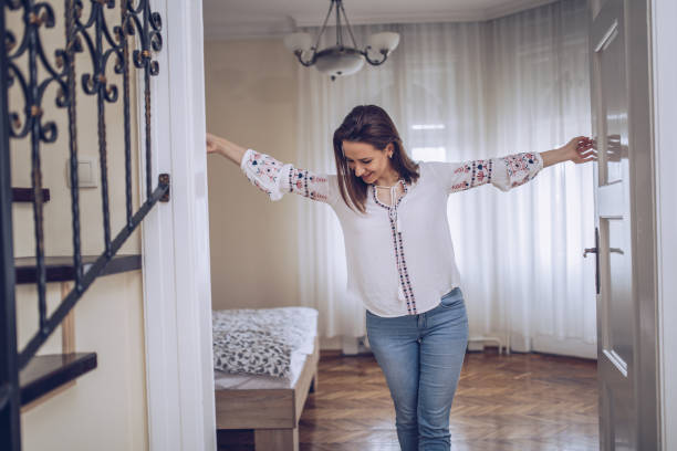 istock Beautiful woman opening door 938862926
