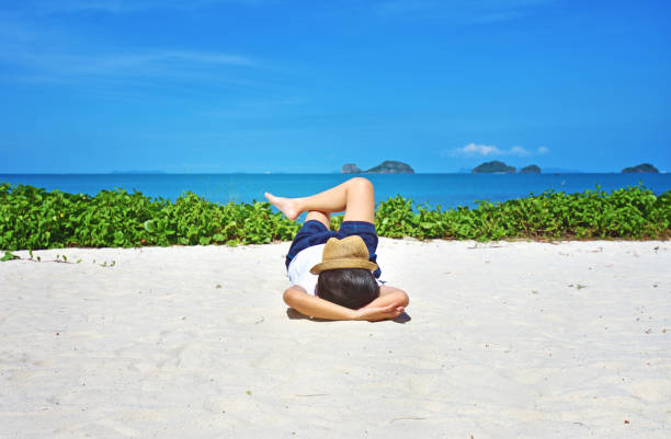 Sleeping woman relaxing on beach ocean background.