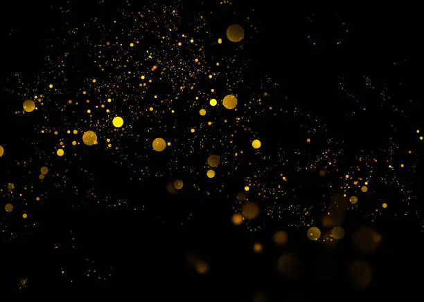 Photo of Gold glittering star light and bokeh.Magic dust abstract background element for your product.