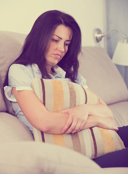 istock Adult sad female melancholy with pillow 938876528