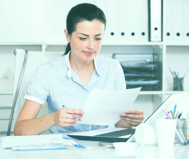 istock Thinking female in office sitting at the table 938876596