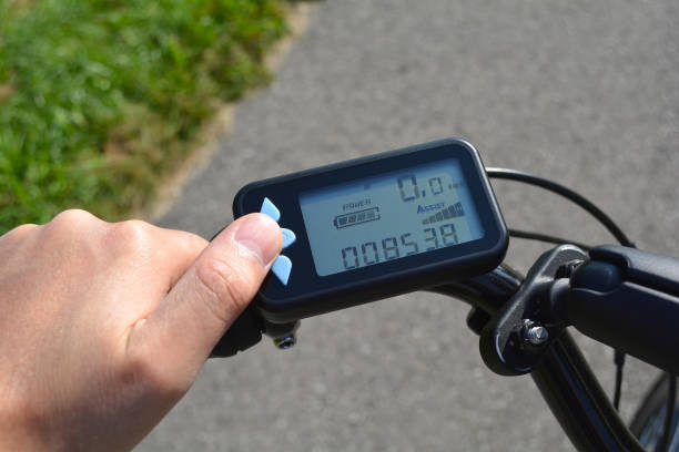 istock A male hand presses a button on a black electronic bicycle scooter. Bike computer installed on a bicycle's handlebar. Man pressing a button on e-bike control board. 938885764