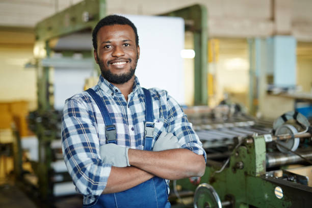istock Positive repairman examining printing machine 938887280